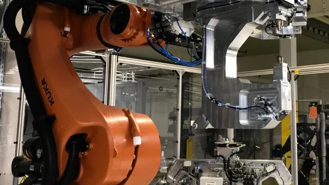 Robotic cell for cutting holes in 12 bumper types